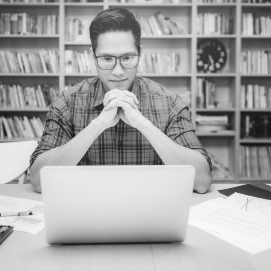 Man Thinking In front of Laptop