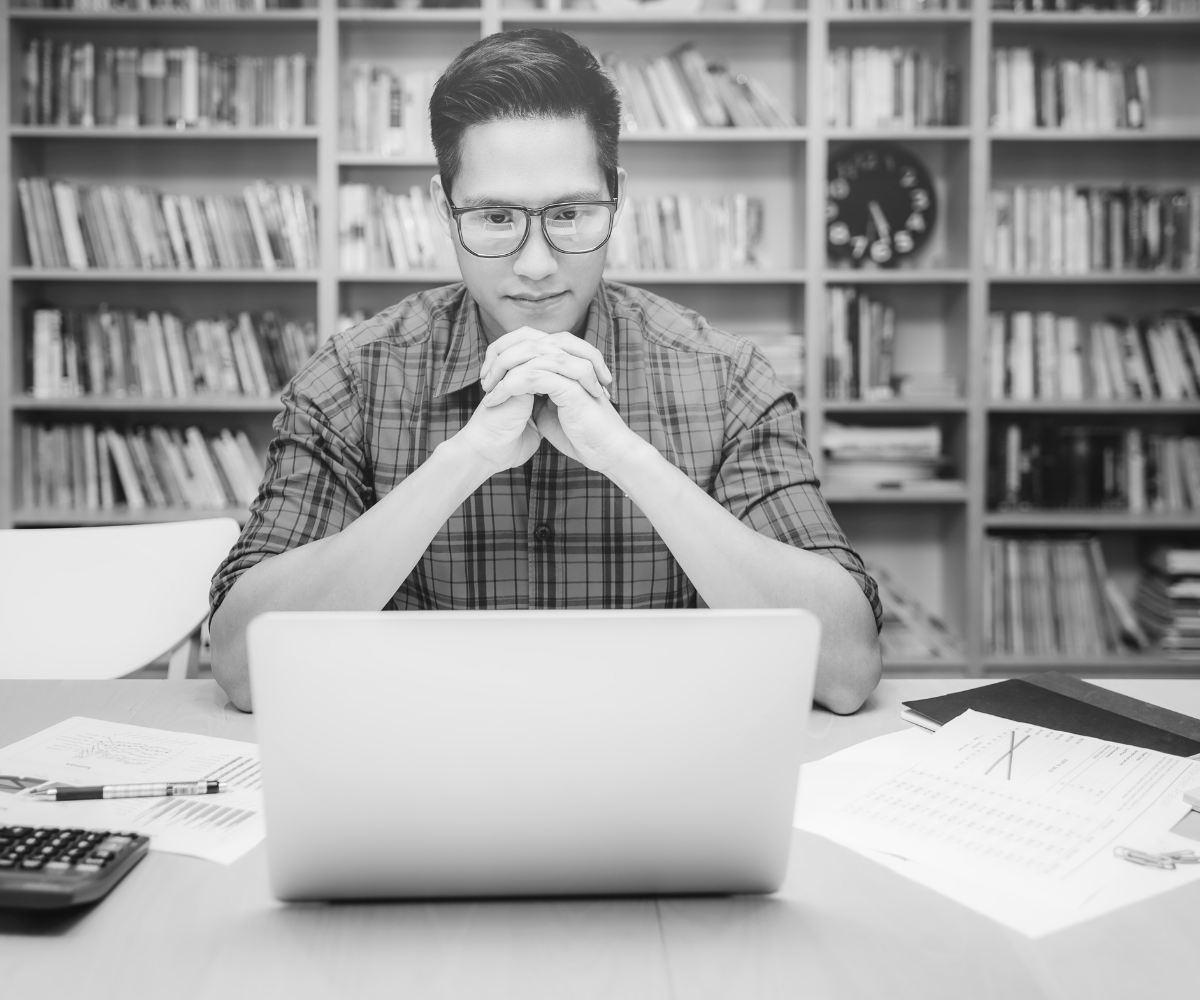 Man Thinking In front of Laptop