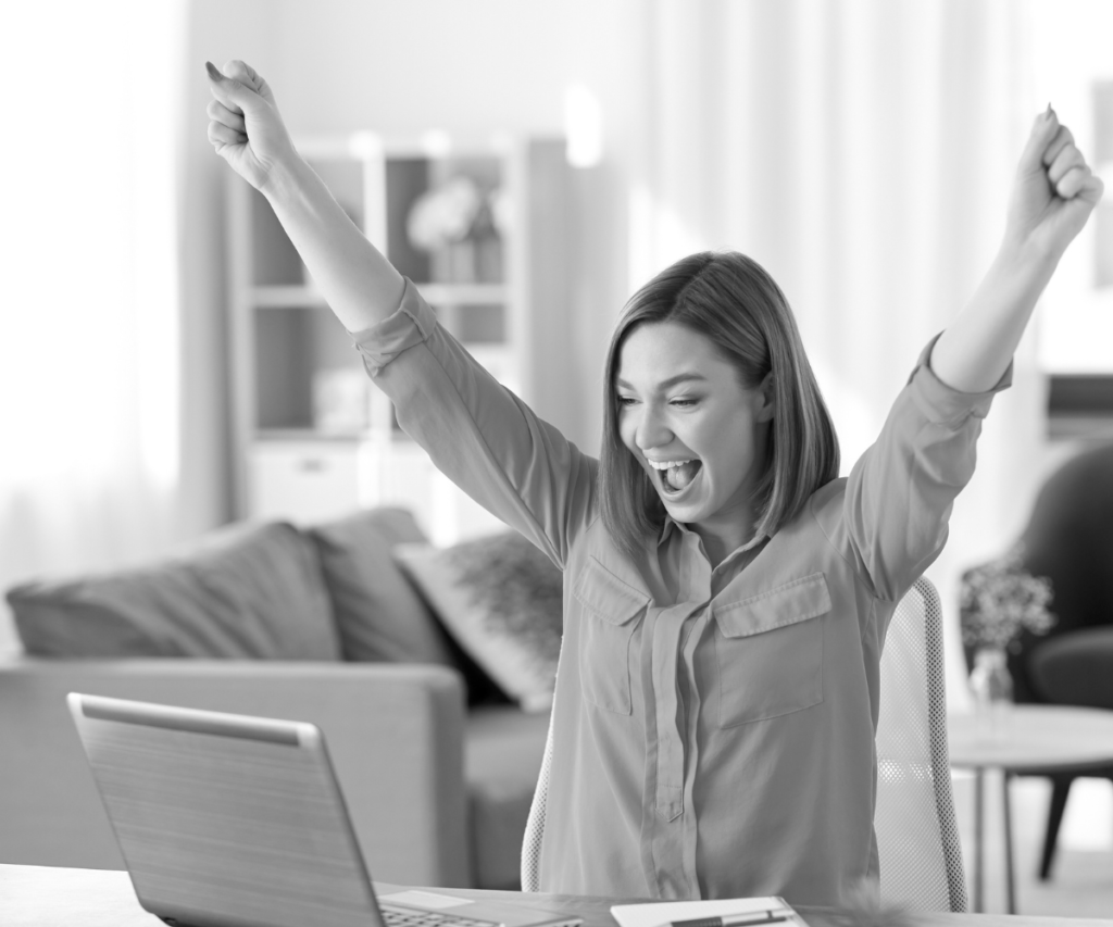 Excited woman working on computer