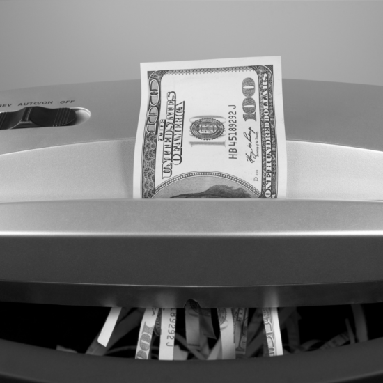 Money being shredded to represent businesses losing money by giving up on advertising too soon