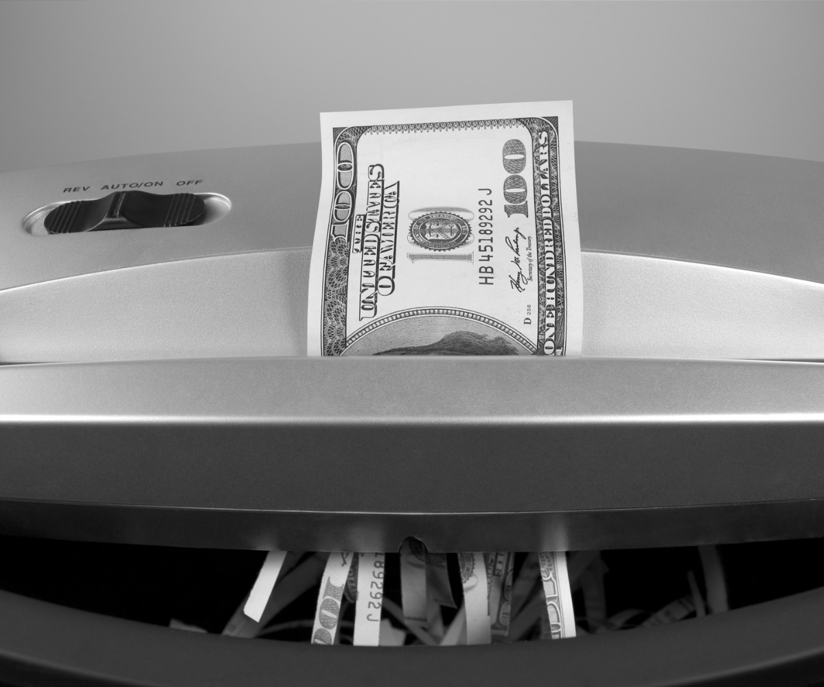 Money being shredded to represent businesses losing money by giving up on advertising too soon