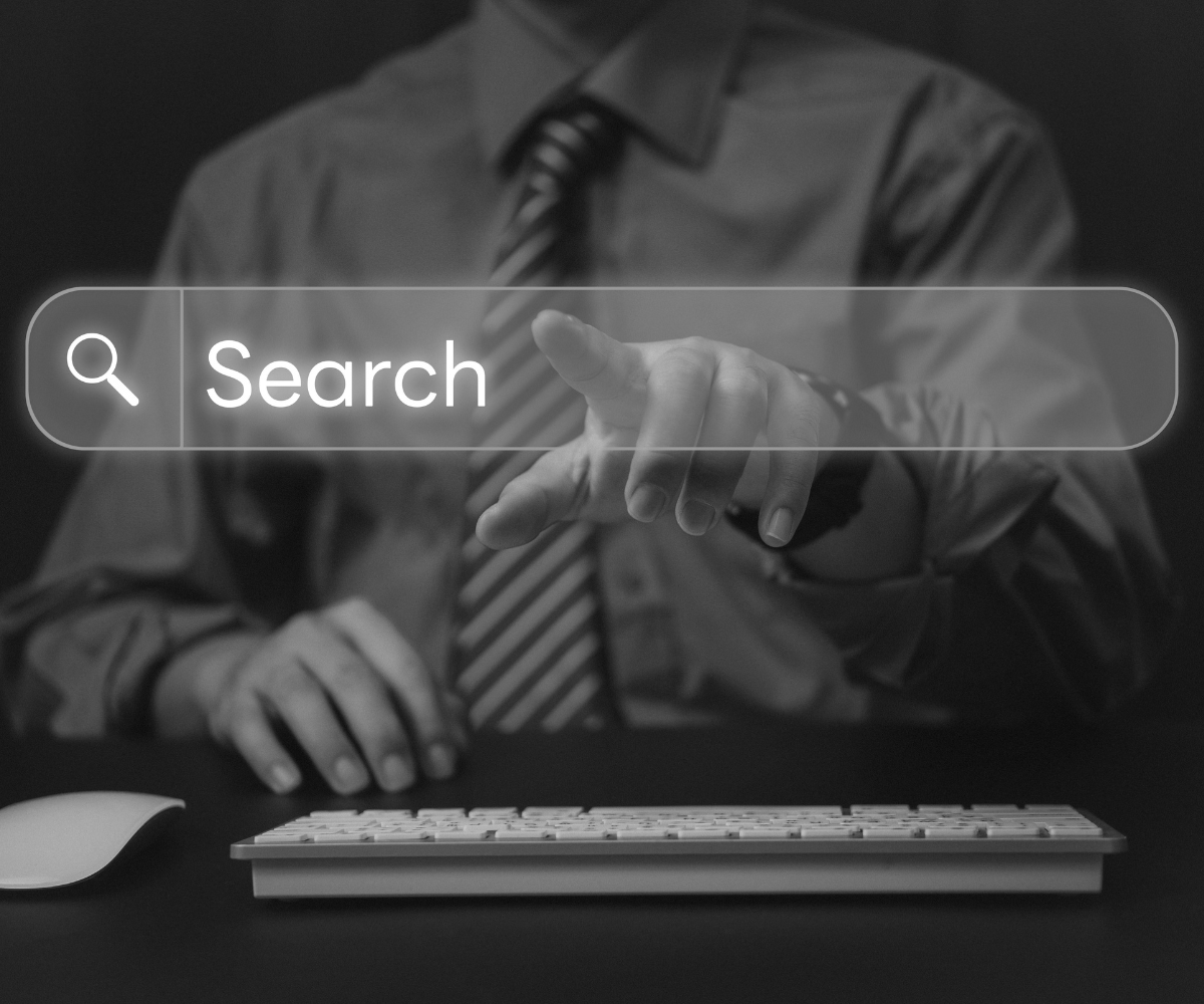 Business owner using an online search bar to find services, representing businesses trying to improve search visibility and show up when people search online.