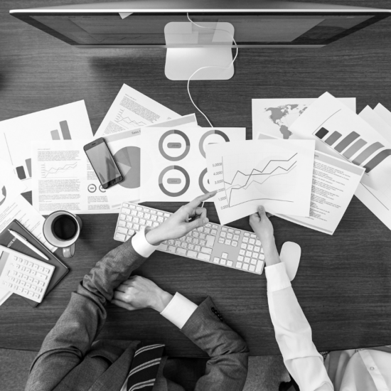 Marketing reports and analytics on a desk representing a Facebook page with high activity but low lead generation and poor business results.