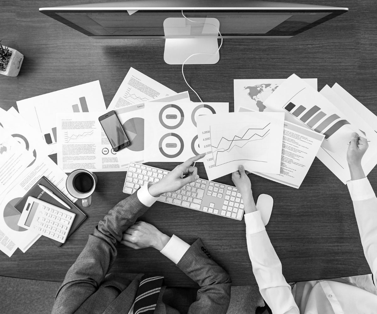 Marketing reports and analytics on a desk representing a Facebook page with high activity but low lead generation and poor business results.