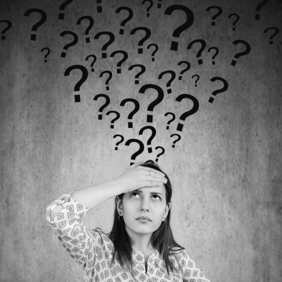 Business owner surrounded by question marks while wondering whether competitors are the reason for slow business growth and marketing results.