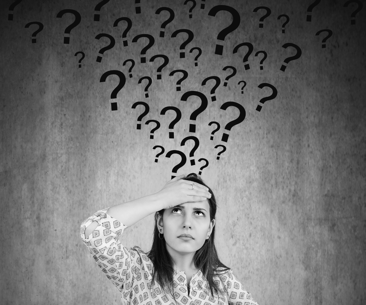 Business owner surrounded by question marks while wondering whether competitors are the reason for slow business growth and marketing results.